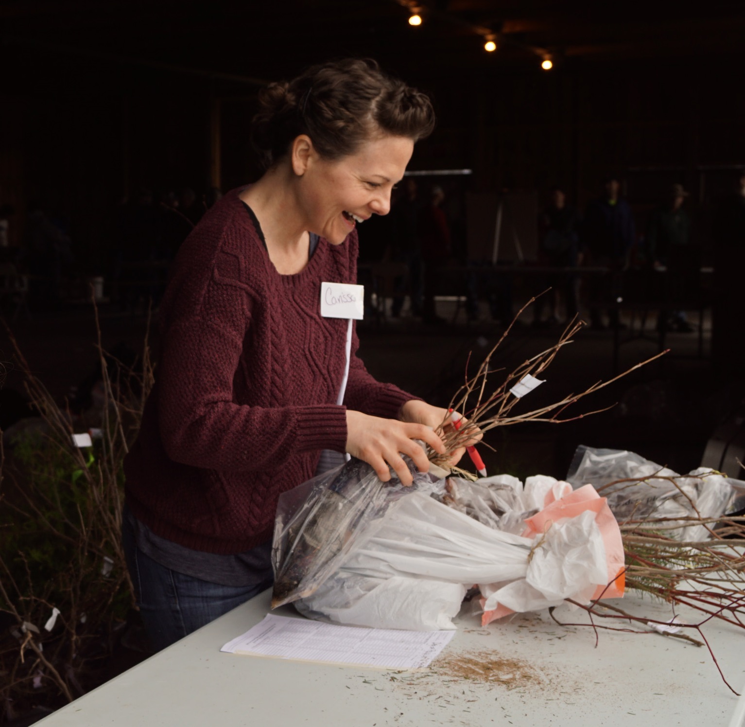 Volunteer Carissa Stein packages an order of trees