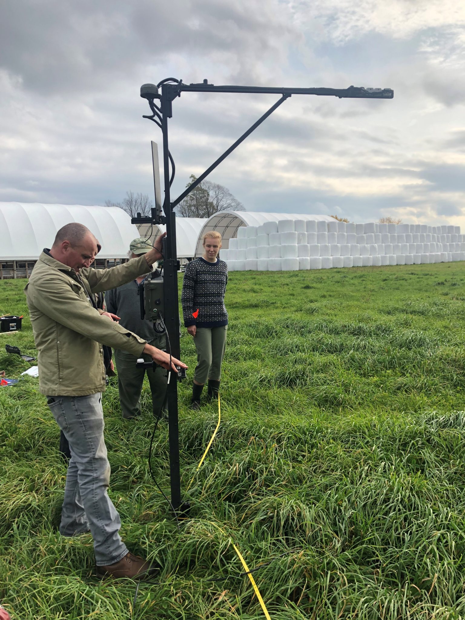 Abe Collins, an advocate of contracting farmers to create measurable improvements in ecosystem services, demonstrates a measurement tool he calls “the Grazibrator” on Choiniere Family Farm in Hiighgate. 