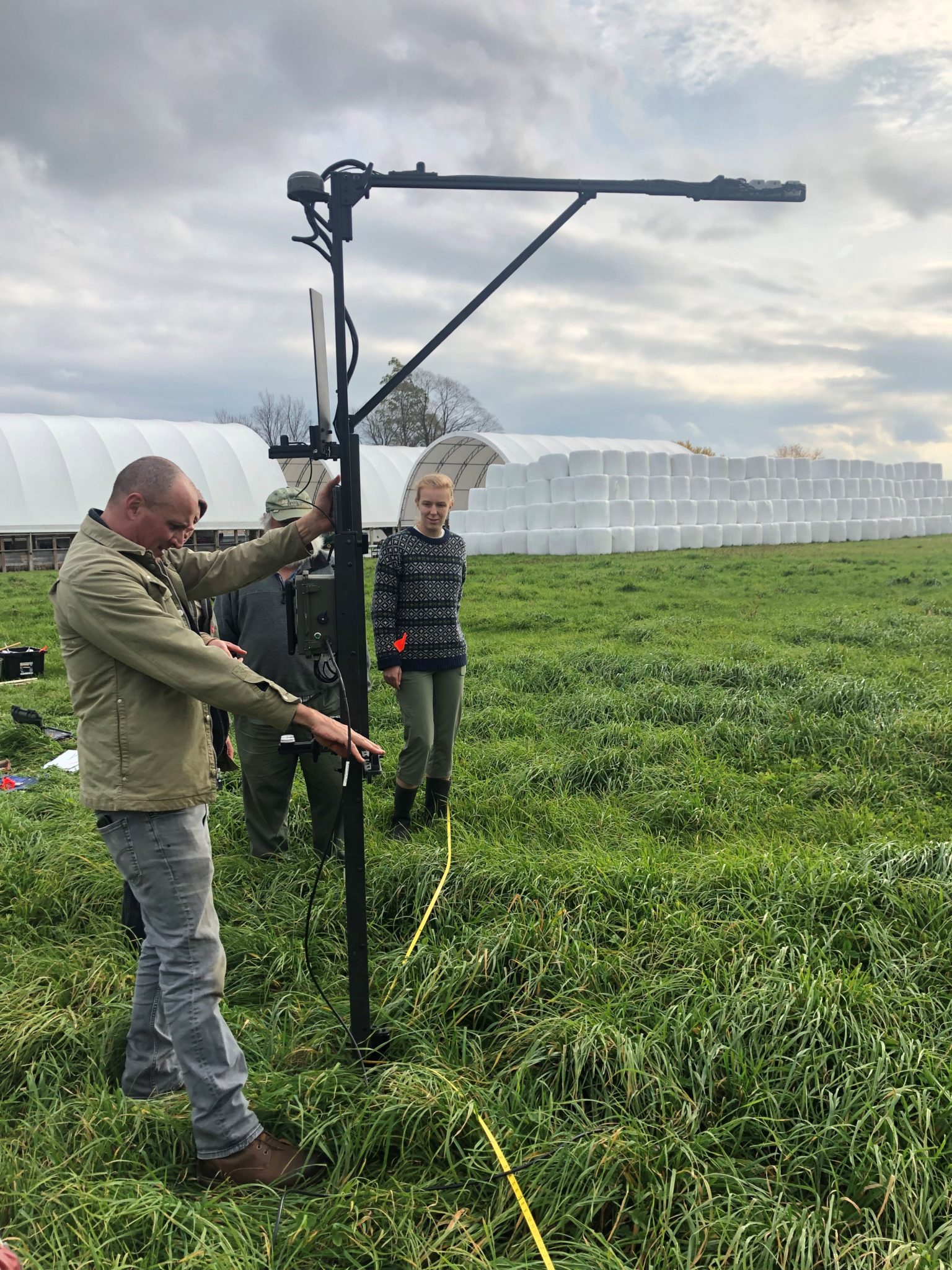 Abe Collins, an advocate of contracting farmers to create measurable improvements in ecosystem services, demonstrates a measurement tool he calls “the Grazibrator” on Choiniere Family Farm in Hiighgate. 