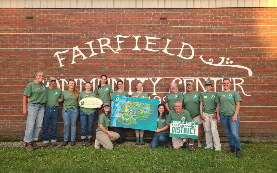 Staff and supervisors against a brick wall
